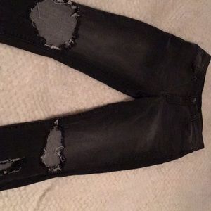 Arizona black jeans with cuts in knee and calf.